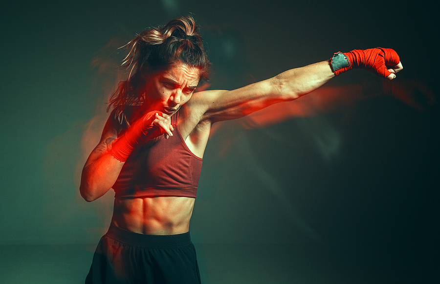 Female MMA fighter performs painful choke hold, Stock image